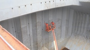 Hold & Deck De-Scaling — Rustibus descaling rig prepping a cargo hold between loads.